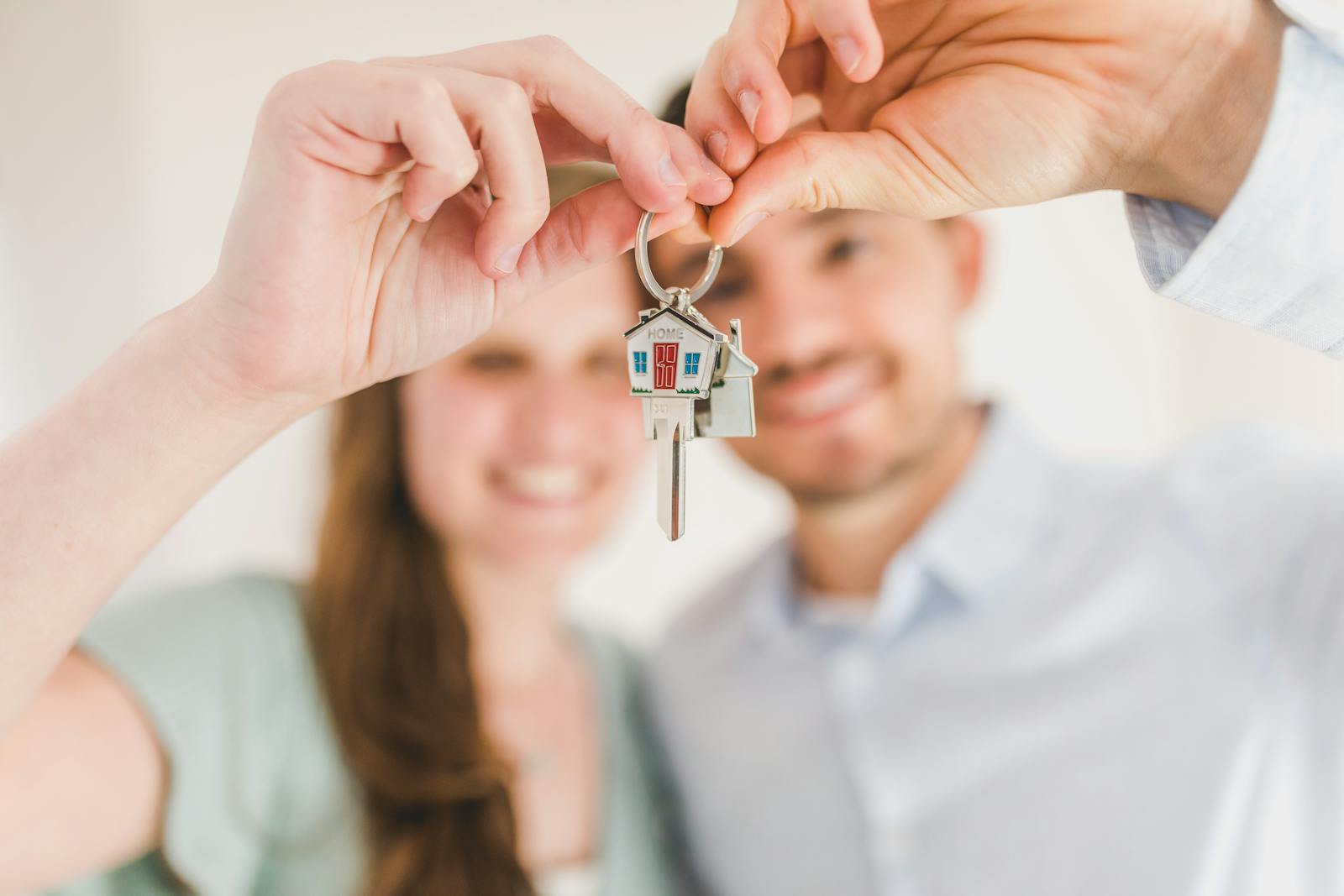 homeowner Young couple holding keys to their new home, symbolizing a fresh start and investment in real estate.